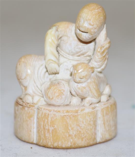 A Japanese ivory netsuke of a Sennin and a shi-shi, first half 18th century, 4.3cm, repair to right arm